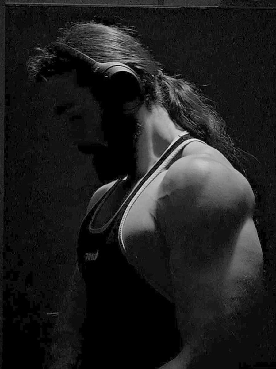 Trenton Blume at the gym, head down, headphones on